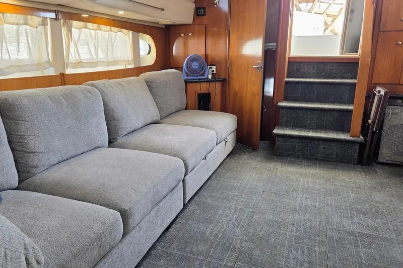 Slide: The Image of Interior of 2000 Carver 396 Motor Yacht with gray sofa and carpeted stairs. - 24