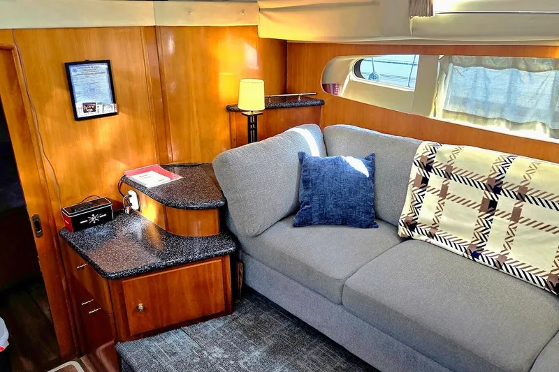 Slide: The Image of Interior of 2000 Carver 396 Motor Yacht with cozy seating and elegant wood paneling. - 26
