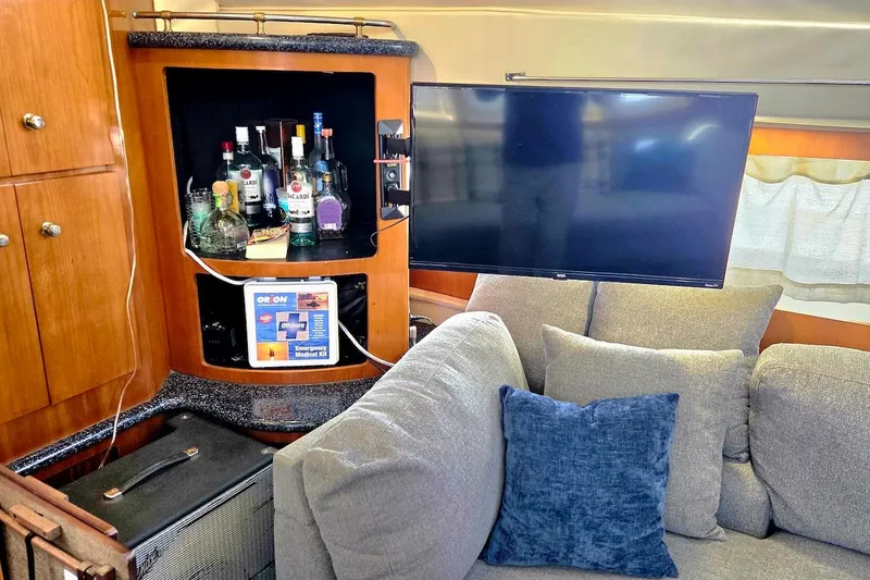 Slide: The Image of Interior of 2000 Carver 396 Motor Yacht with bar, TV, and cozy seating area. - 31