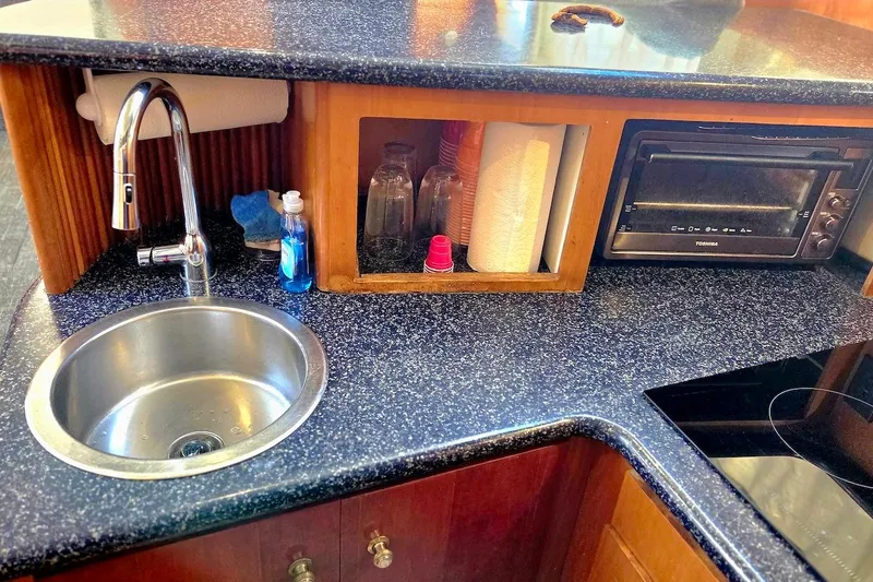 Slide: The Image of Compact kitchen area in 2000 Carver 396 Motor Yacht with sink and appliances. - 35