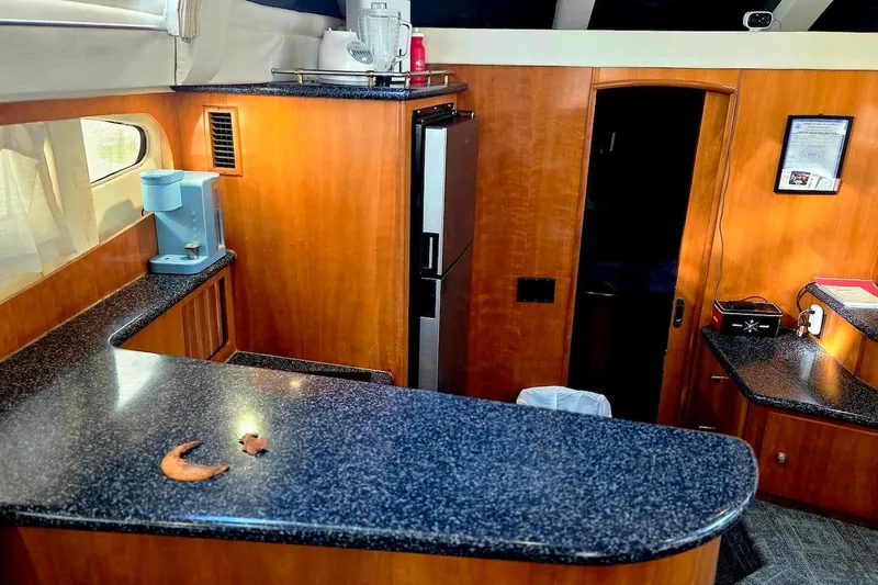 Slide: The Image of Interior of 2000 Carver 396 Motor Yacht with modern kitchen and wood cabinetry. - 36