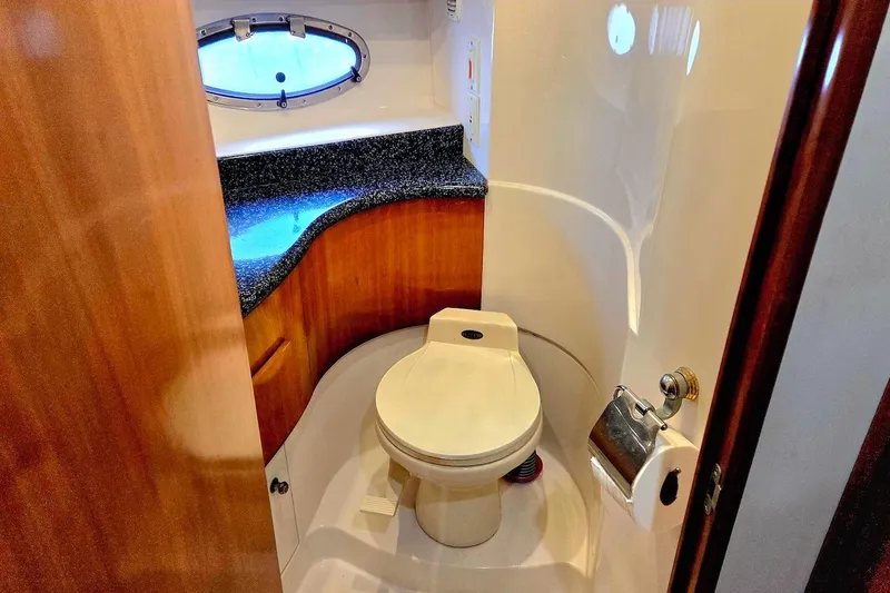 Slide: The Image of Bathroom interior of 2000 Carver 396 Motor Yacht with porthole and wooden cabinetry. - 49