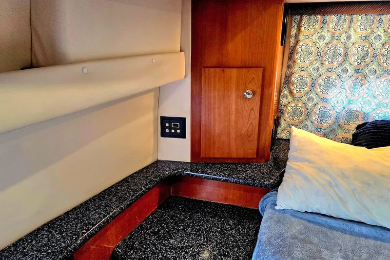 Slide: The Image of Interior cabin of 2000 Carver 396 Motor Yacht with patterned curtains and cozy bedding. - 51