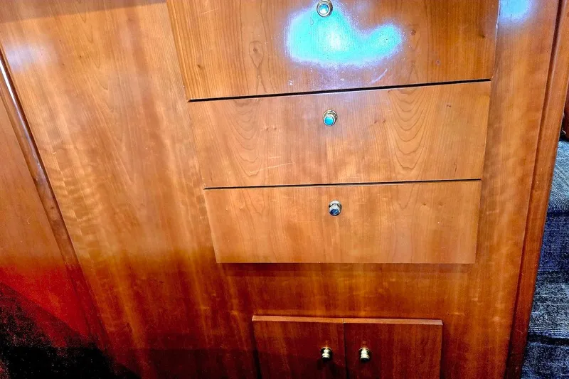 Slide: The Image of Wooden cabinetry inside a 2000 Carver 396 Motor Yacht, featuring drawers and polished knobs. - 53