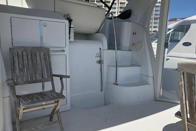 Slide: The Image of 2000 Carver 396 Motor Yacht interior with wooden chair and stairs, showcasing elegant design. - 6