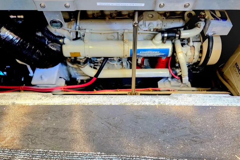 Slide: The Image of Engine compartment of a 2000 Carver 396 Motor Yacht, showcasing mechanical components. - 60