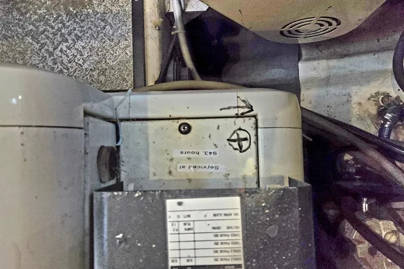 Slide: The Image of Engine compartment of 2000 Carver 396 Motor Yacht, showing mechanical components and service label. - 61