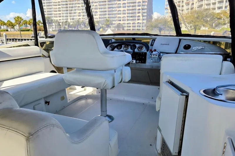 Slide: The Image of Interior view of 2000 Carver 396 Motor Yacht cockpit with white seating and navigation equipment. - 7