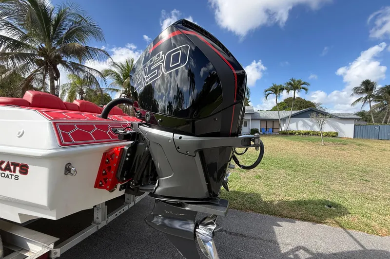 Slide: The Image of HellKats 30 boat with powerful engine, palm trees, and blue sky in the background. - 12