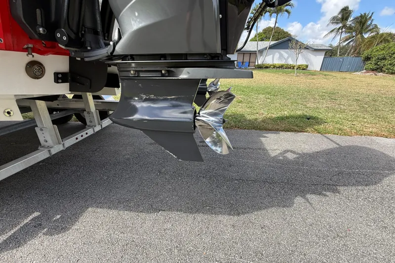 Slide: The Image of Outboard motor of 2020 HellKats 30 boat on trailer, shiny propeller visible. - 13