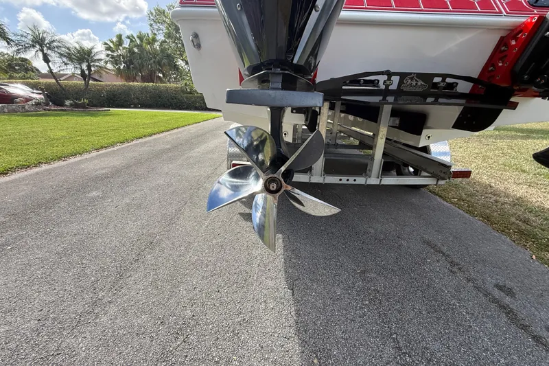 Slide: The Image of HellKats 30 boat propeller, 2020 model, on a trailer in a sunny driveway. - 14