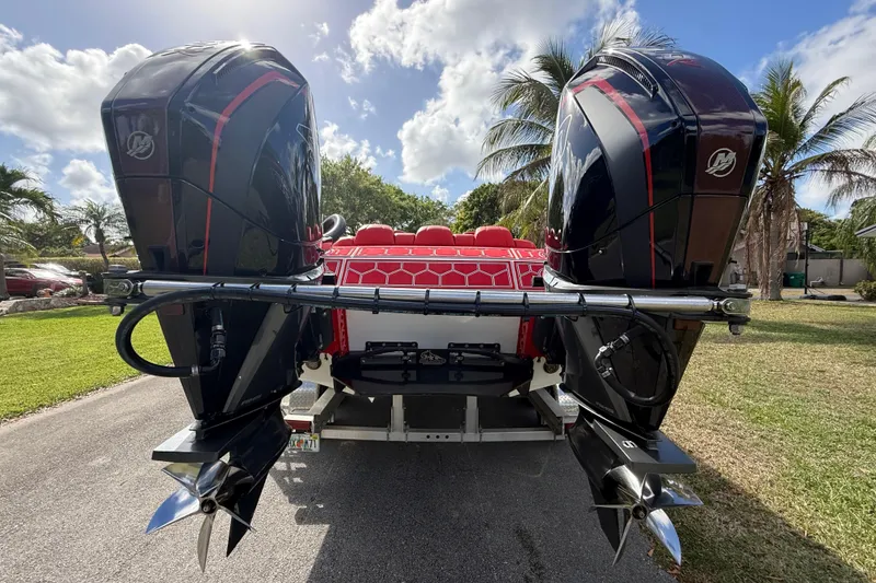 Slide: The Image of 2020 HellKats 30 boat with dual outboard motors, parked on a sunny day. - 15
