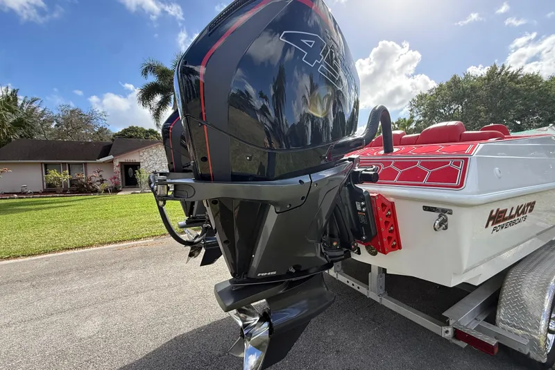 Slide: The Image of 2020 HellKats 30 powerboat with powerful outboard engine, parked in residential area. - 16