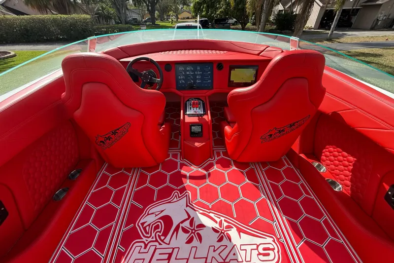 Slide: The Image of Red interior of 2020 HellKats 30 boat with logo and dashboard displays. - 25