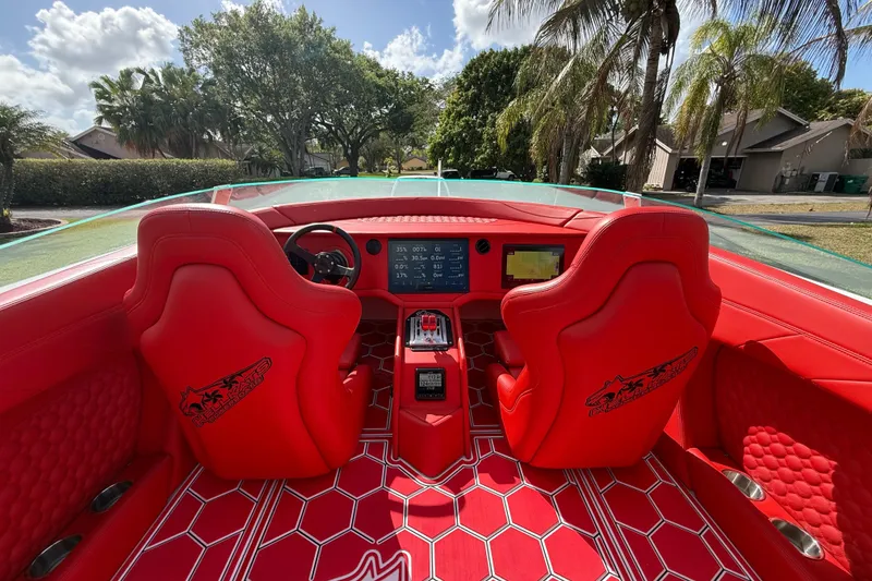 Slide: The Image of Red interior of 2020 HellKats 30 boat with modern dashboard and seating. - 26