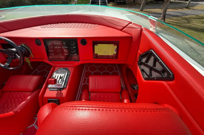 Slide: The Image of Red interior of a 2020 HellKats 30 boat with digital dashboard and steering wheel. - 29