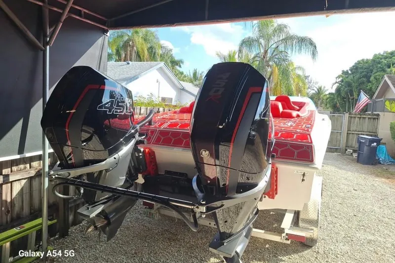 Slide: The Image of 2020 HellKats 30 powerboat on trailer, featuring a powerful outboard engine. - 3