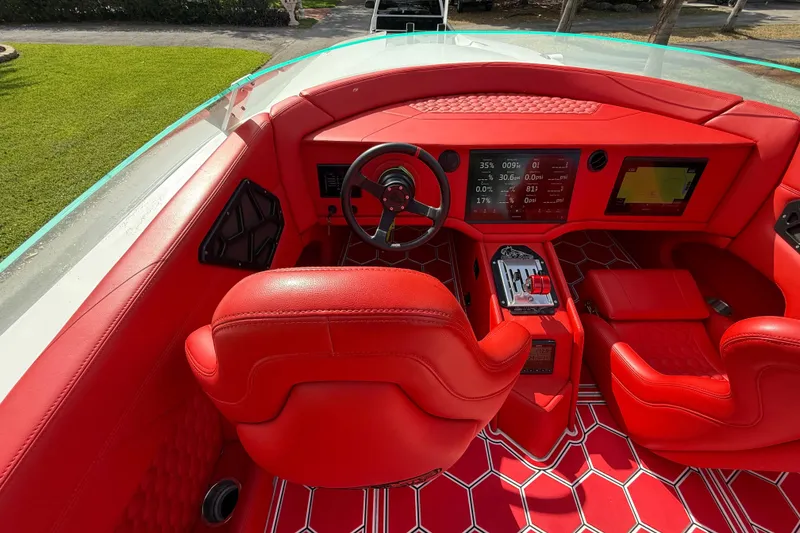 Slide: The Image of Red interior of 2020 HellKats 30 boat with modern dashboard and steering wheel. - 30