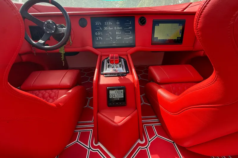 Slide: The Image of Red interior of 2020 HellKats 30 with modern dashboard and digital displays. - 32