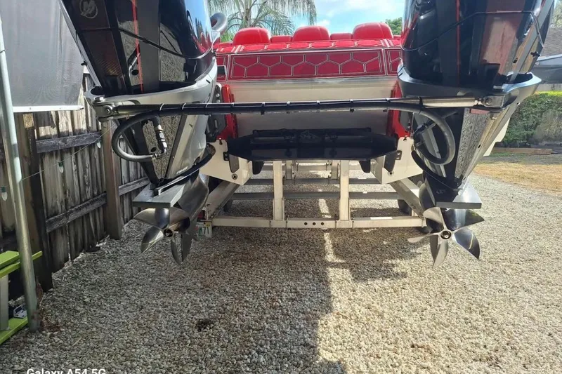 Slide: The Image of HellKats Powerboats logo on 2020 model 30, white hull, blue sky background. - 4