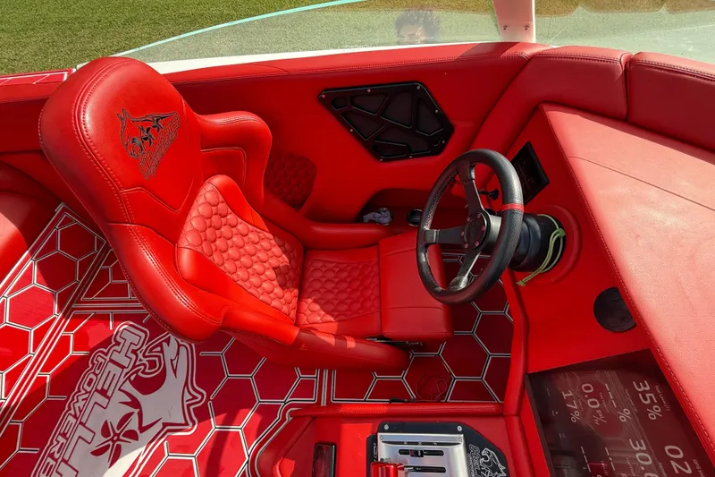 Slide: The Image of Red interior of 2020 HellKats 30 boat with hexagonal patterns and steering wheel. - 40