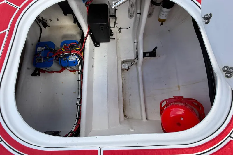 Slide: The Image of Open compartment of 2020 HellKats 30 boat showing batteries and wiring. - 45