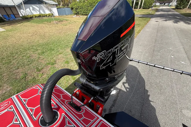 Slide: The Image of Outboard motor on HellKats 30 boat, 2020 model, parked on a driveway. - 57