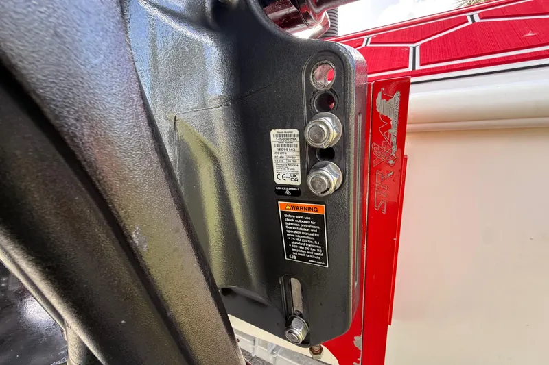 Slide: The Image of Close-up of HellKats 30 boat component with warning label and bolts, 2020 model. - 59