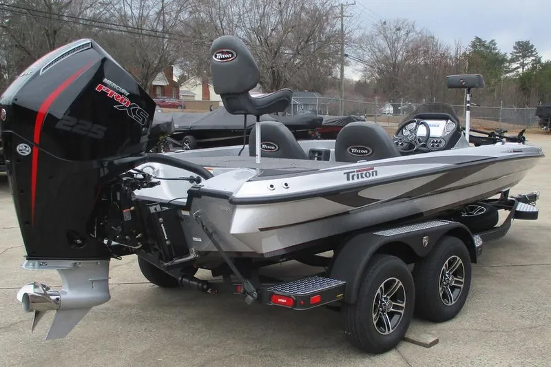Slide: The Image of 2026 Triton 19 TrX Patriot boat with powerful engine and sleek design on trailer. - 3