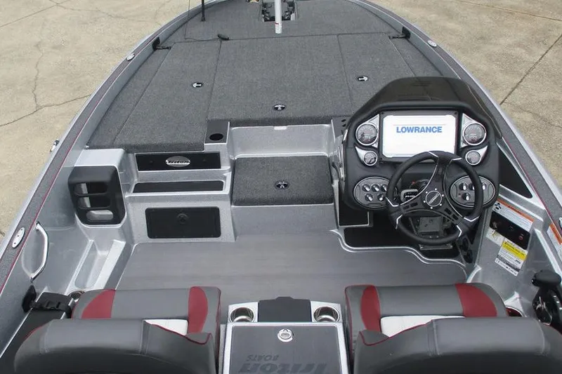 Slide: The Image of 2026 Triton 19 TrX Patriot boat interior with advanced navigation system and dual seating. - 7