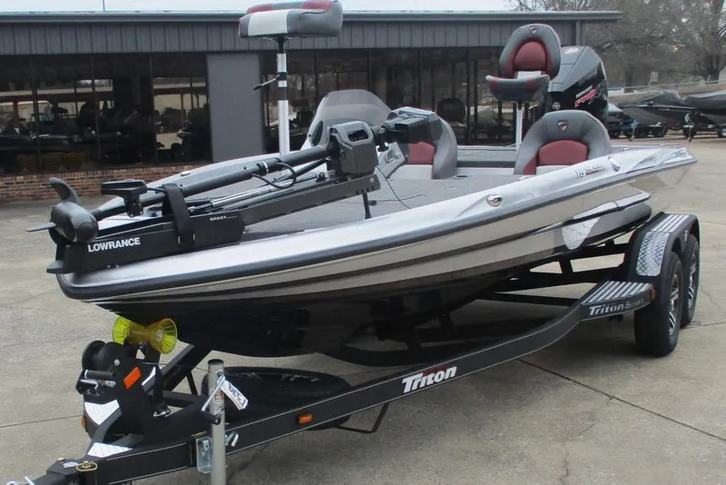 Slide: The Image of 2026 Triton 19 TrX Patriot boat on trailer, featuring Lowrance equipment. - 9