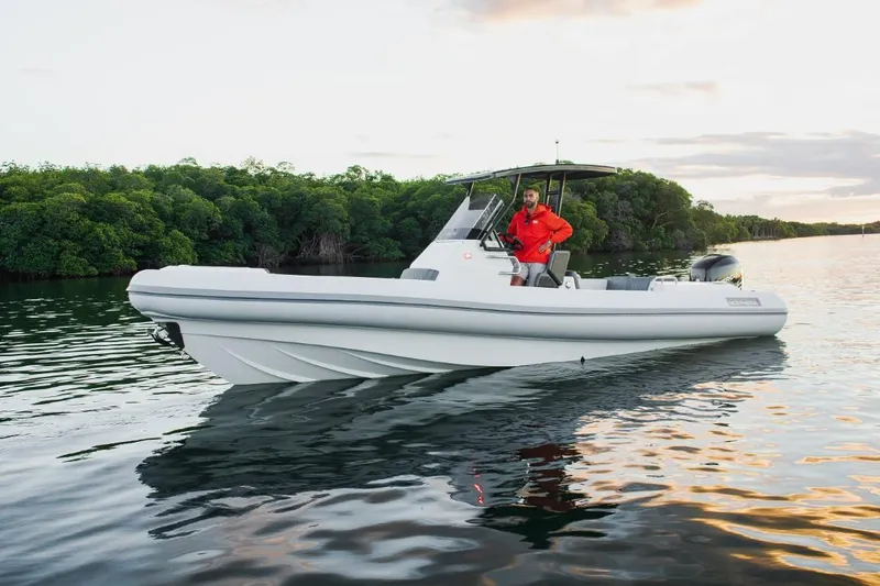 Slide: The Image of 2024 Northstar Orion 8 boat on calm water with lush green background. - 10