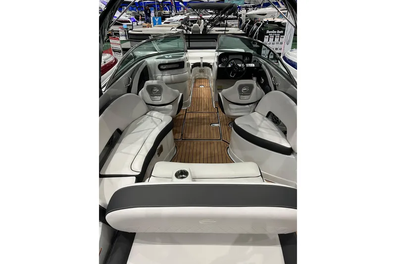 Slide: The Image of 2023 Crownline Eclipse E255 boat interior with luxurious seating and wood flooring. - 4