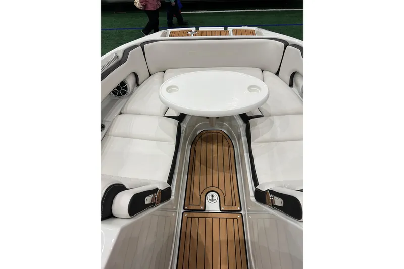 Slide: The Image of 2023 Crownline Eclipse E255 boat interior with white seating and wooden flooring. - 6