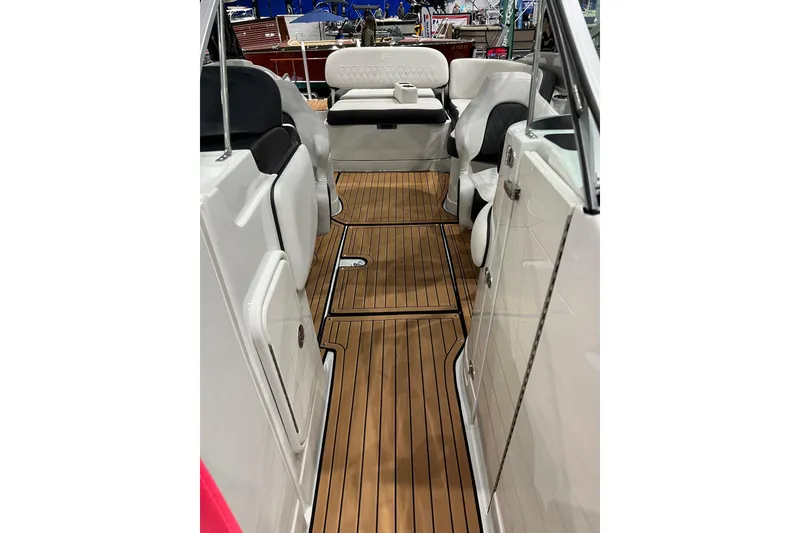 Slide: The Image of 2023 Crownline Eclipse E255 boat interior with sleek seating and wood-style flooring. - 7