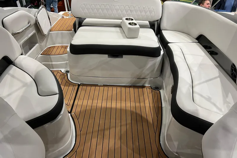 Slide: The Image of 2023 Crownline Eclipse E255 boat interior with white seating and wood-style flooring. - 8