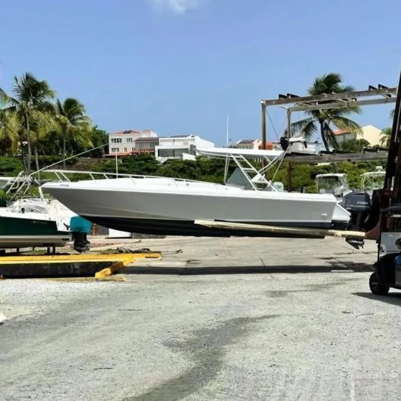The Image of 1996 Intrepid 356 Cuddy on a boat lift outdoors. - 0
