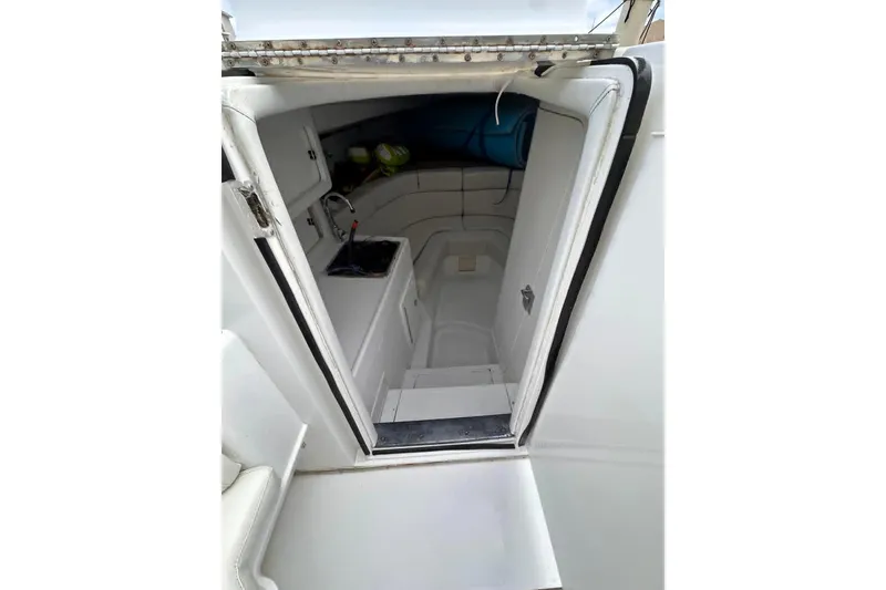 Slide: The Image of 1996 Itrepid 35 Cuddy cabin interior with seating and storage. - 10