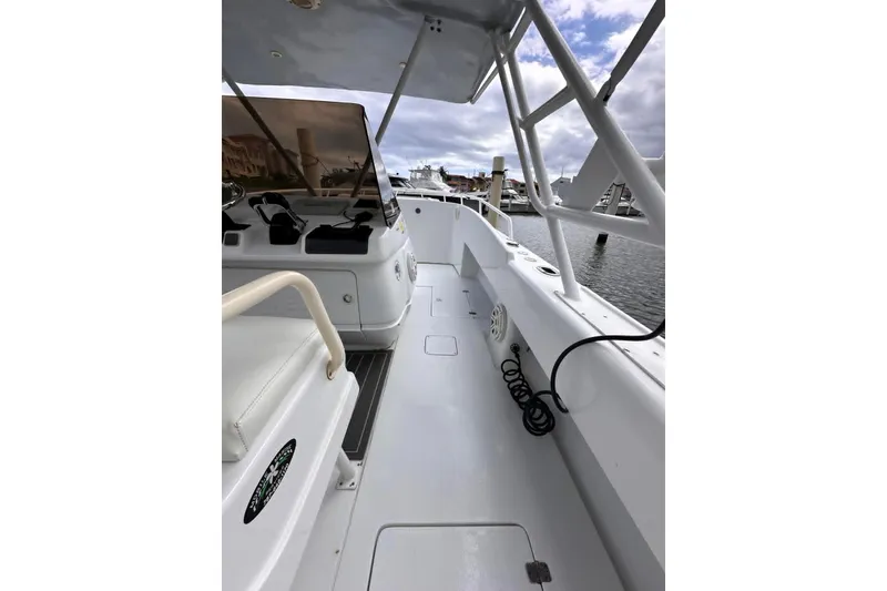 Slide: The Image of 1996 Itrepid 35 Cuddy boat interior with helm, docked at marina. - 11