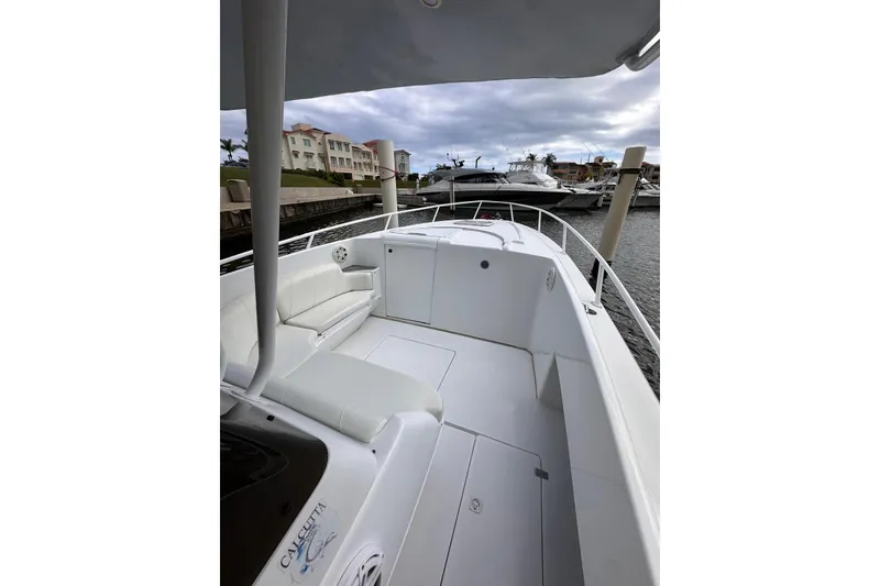 Slide: The Image of 1996 Itrepid 35 Cuddy boat with white seating, docked in a marina. - 7