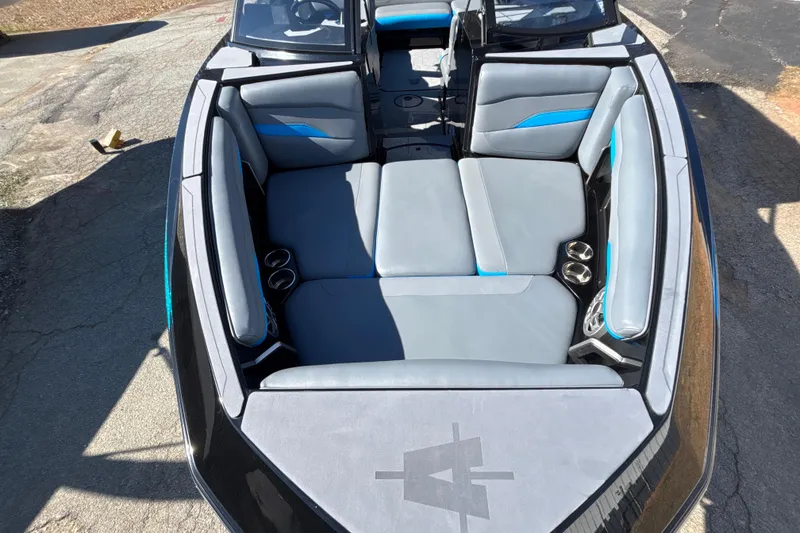 Slide: The Image of 2023 Axis T220 boat interior with gray and blue seating, cup holders, and sleek design. - 13