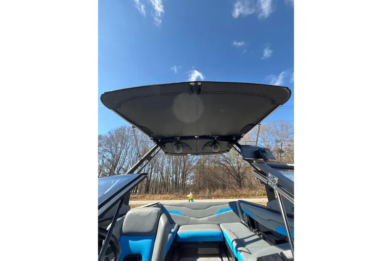 Slide: The Image of 2023 Axis T220 boat interior with open canopy under clear blue sky. - 17