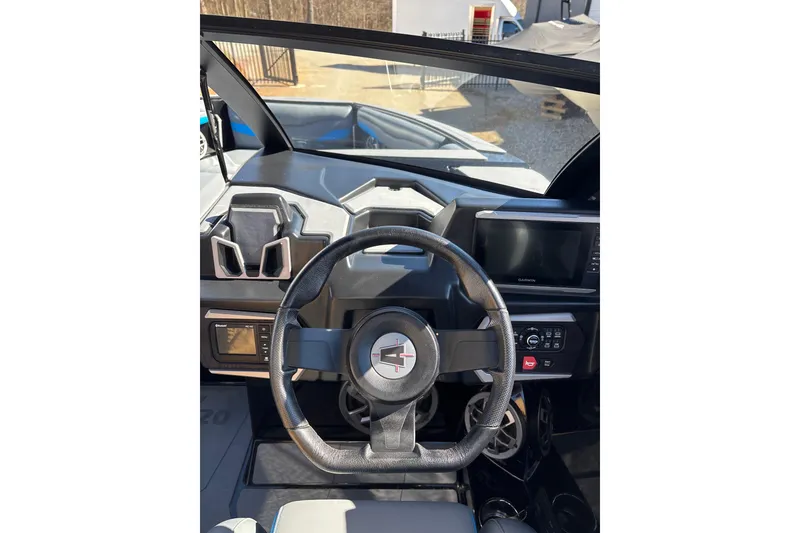 Slide: The Image of 2023 Axis T220 boat dashboard with steering wheel and digital display. - 19