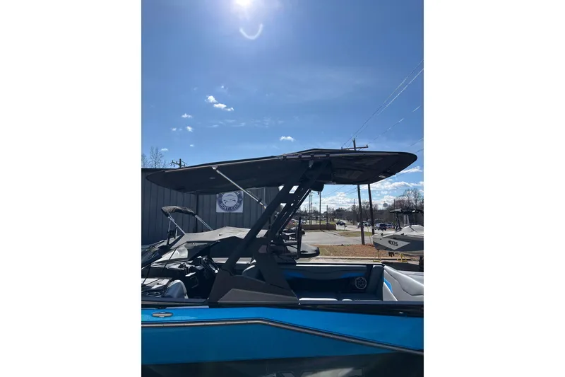 Slide: The Image of 2023 Axis T220 boat under clear blue sky, showcasing sleek design and modern features. - 9