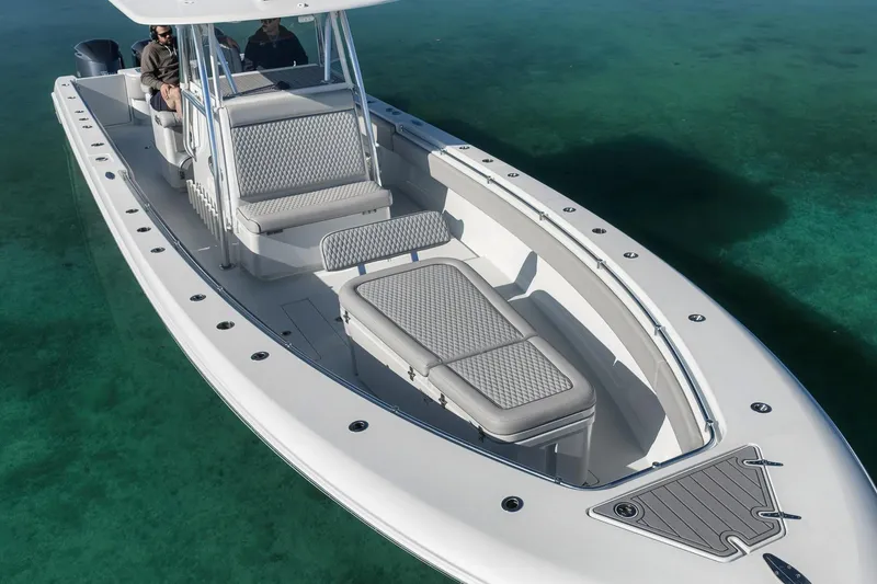 Slide: The Image of 2021 Contender 39 ST boat on clear water, showcasing sleek design and spacious seating. - 10