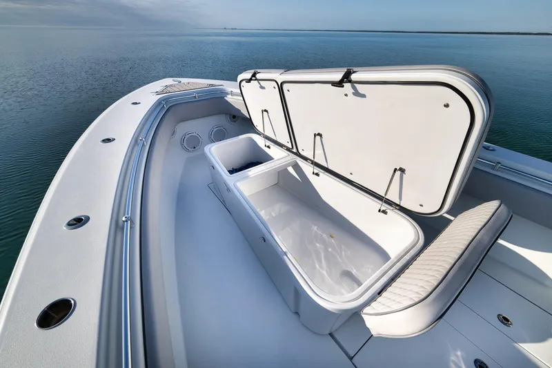 Slide: The Image of 2021 Contender 39 ST boat with open storage compartment on calm water. - 13