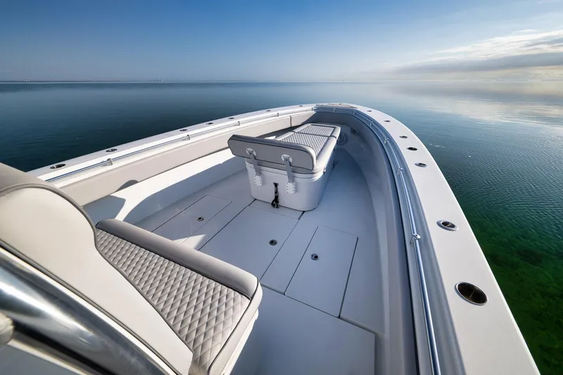 Slide: The Image of 2021 Contender 39 ST boat on calm water, featuring sleek design and spacious seating. - 16