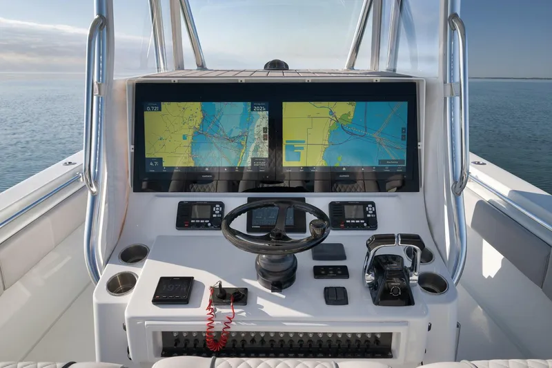 Slide: The Image of 2021 Contender 39 ST boat dashboard with dual navigation screens and steering wheel. - 17