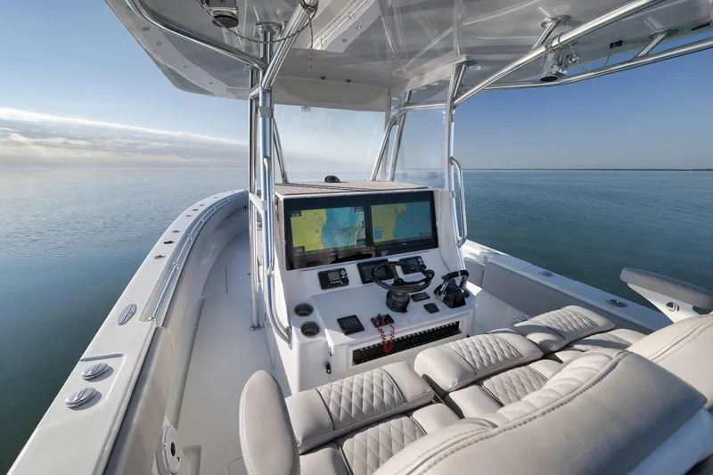 Slide: The Image of 2021 Contender 39 ST boat cockpit with navigation system on calm water. - 19