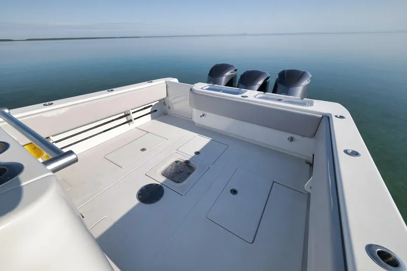 Slide: The Image of 2021 Contender 39 ST boat deck with triple outboard motors on calm water. - 23